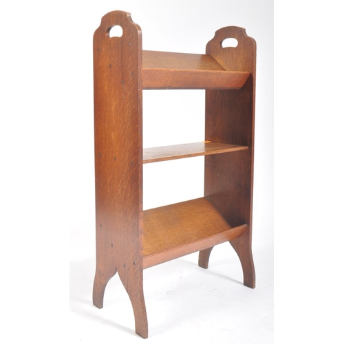 269 - A 20th century, circa 1920s Art & Crafts oak free standing bookshelf trough. The having a sloped top... 