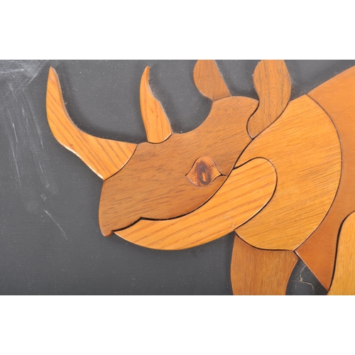 283 - A vintage 20th century teak mosaic style decorative wall panel with rhino figure. The panel measurin... 