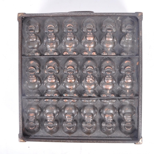31 - A retro 20th century copper and cast iron chocolate mould, featuring three lines of chirping chicks ... 