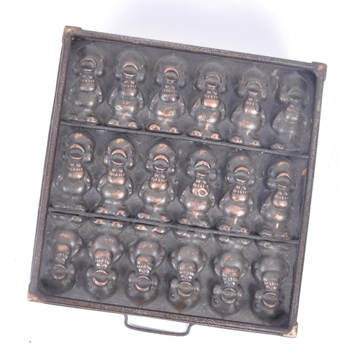 31 - A retro 20th century copper and cast iron chocolate mould, featuring three lines of chirping chicks ... 
