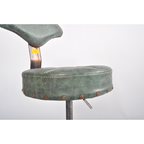 72 - A 20th century industrial / factory workmen's swivel office desk chair having a shaped green leather... 