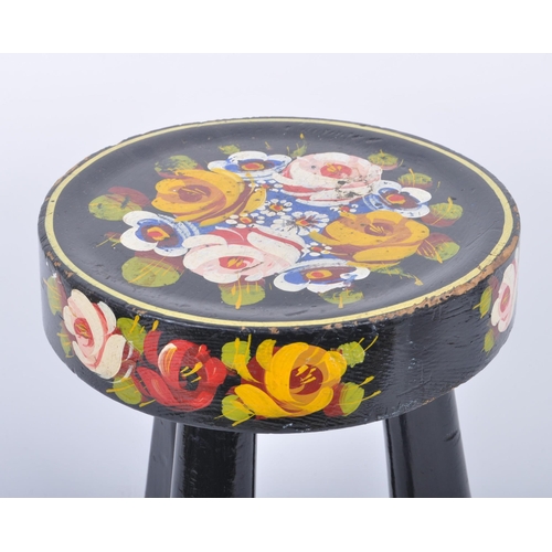 77 - A 20th century painted wood bargeware style low stool. The stool having a circular top over tripod i... 