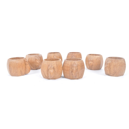 78 - Robert ' Mouseman ' Thompson of Kilburn - A set of eight solid English oak hand carved faceted napki... 