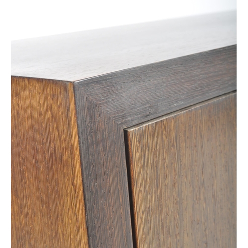 85 - A contemporary Wenge ( Millettia laurentii ) veneered low media / hi-fi unit sideboard credenza. The... 