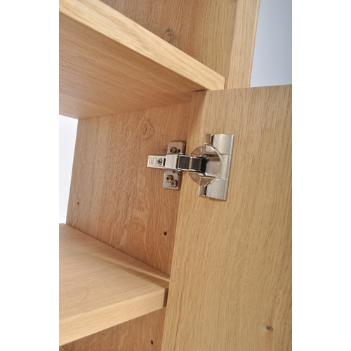 627 - A contemporary Milano solid oak two door open display unit bookcase. The bookcase having straight to... 