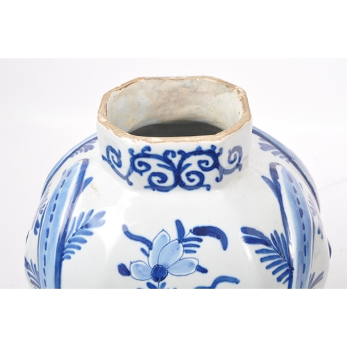 122 - An early 20th century earthenware urn / lidded vase, with moulded lion / dog mounted atop, seated up... 