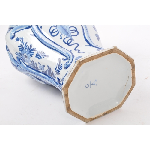 122 - An early 20th century earthenware urn / lidded vase, with moulded lion / dog mounted atop, seated up... 