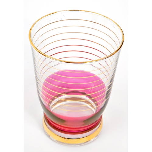 125 - A set of vintage retro cranberry drinking glasses with matching jug. Comprising of; 6 x matching
 dr... 