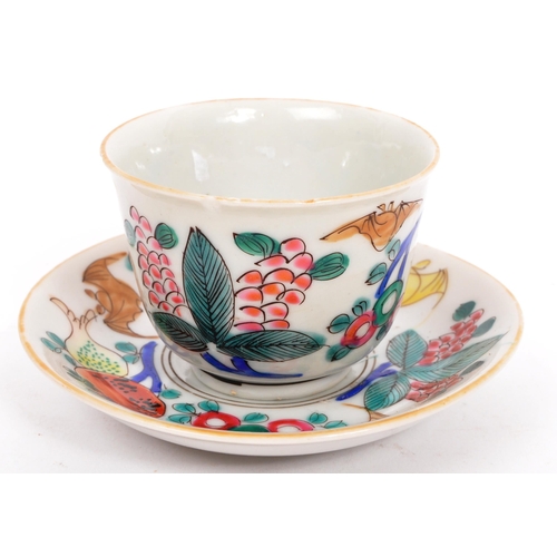 126 - A Chinese / Oriental ceramic porcelain cup and saucer having hand painted multi-coloured foliate and... 