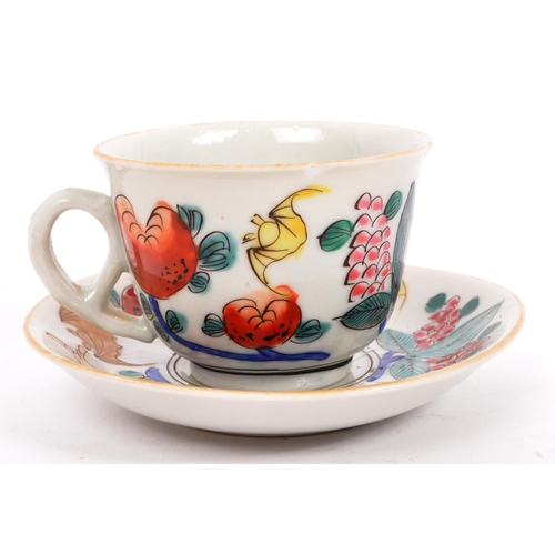 126 - A Chinese / Oriental ceramic porcelain cup and saucer having hand painted multi-coloured foliate and... 