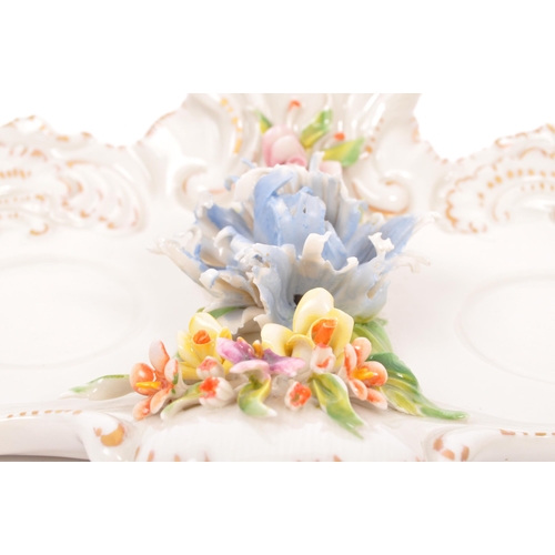 133 - A vintage 20th Century Capodimonte marked porcelain inkwell and two jugs, with china flower relief t... 