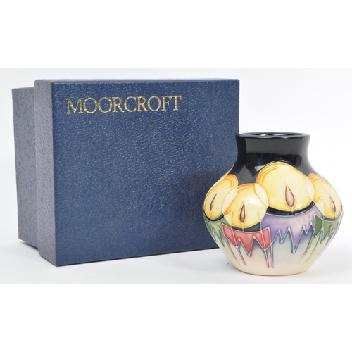 152 - Moorcroft - Candlelight - A 20th century Moorcroft vase in the Candlelight pattern designed by Nicol... 