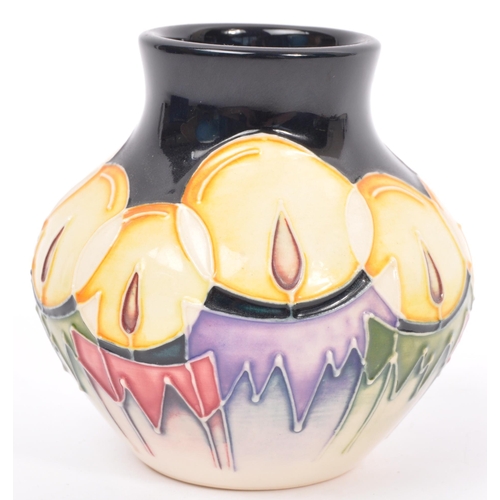 152 - Moorcroft - Candlelight - A 20th century Moorcroft vase in the Candlelight pattern designed by Nicol... 