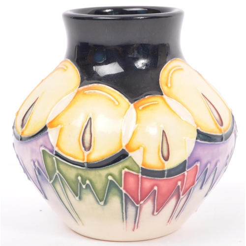 152 - Moorcroft - Candlelight - A 20th century Moorcroft vase in the Candlelight pattern designed by Nicol... 