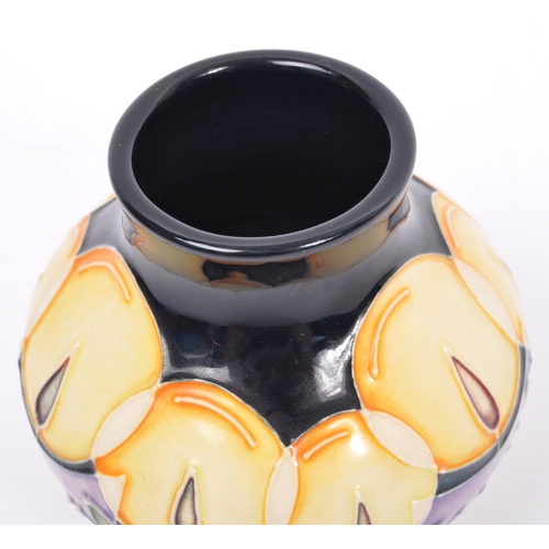 152 - Moorcroft - Candlelight - A 20th century Moorcroft vase in the Candlelight pattern designed by Nicol... 