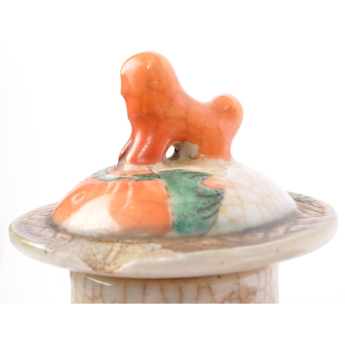 159 - A 19th Century Japanese Kutani lidded dish atop a plinth stand with red ochre grounds and gilded dec... 