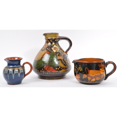 167 - A large Continental ceramic glazed Hans Schneider Folk Art pottery jug of bulbous form together with... 