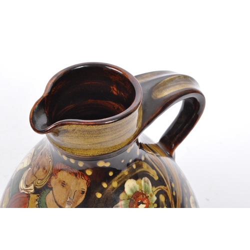 167 - A large Continental ceramic glazed Hans Schneider Folk Art pottery jug of bulbous form together with... 
