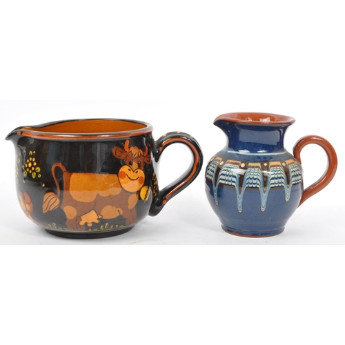 167 - A large Continental ceramic glazed Hans Schneider Folk Art pottery jug of bulbous form together with... 