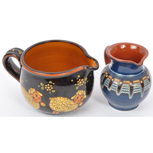 167 - A large Continental ceramic glazed Hans Schneider Folk Art pottery jug of bulbous form together with... 