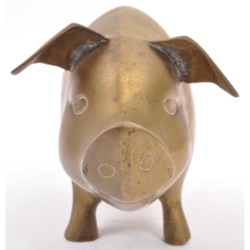 173 - An early 20th Century 1930s large brass figure in the form of a pig with stylised features, standing... 