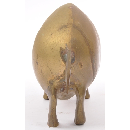 173 - An early 20th Century 1930s large brass figure in the form of a pig with stylised features, standing... 