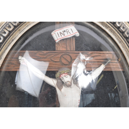 178 - An early 20th Century Catholic stucco crucifix depicting Christ on a wooden cross  against a black b... 