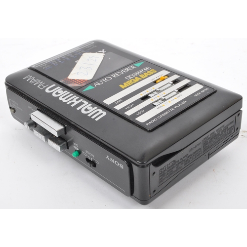 401 - A vintage retro 20th century Sony Walkman Mega Bass portable audio player together with a Walkman CD... 