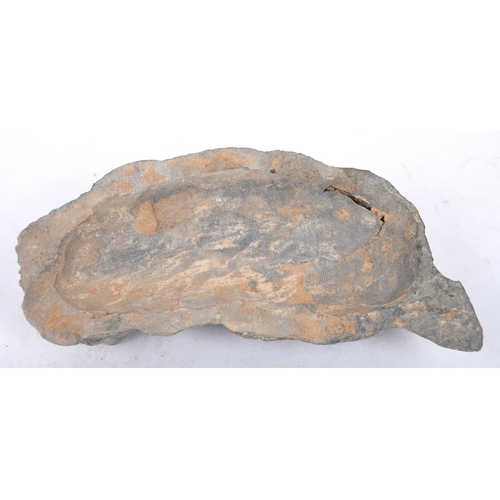 196 - A Tang Dynasty Chinese hand moulded clay earthenware burial funerary figure of a lying dog with pain... 