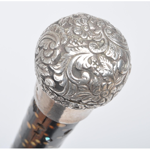 A High Victorian walking stick / cane with silver top, floral repousse  decorated, on mahogany stick