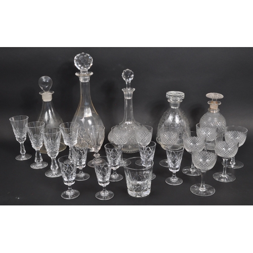 154 - A collection of 19th century and later glass decanters and drinking glasses to include signed Tudor ... 