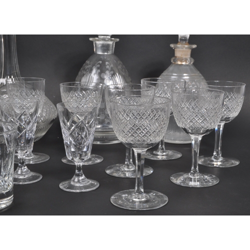 154 - A collection of 19th century and later glass decanters and drinking glasses to include signed Tudor ... 