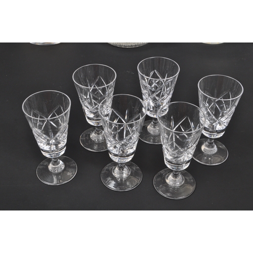 154 - A collection of 19th century and later glass decanters and drinking glasses to include signed Tudor ... 