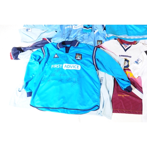 399 - A large collection of vintage 20th century and later Manchester City Football club shirts, T shirts ... 