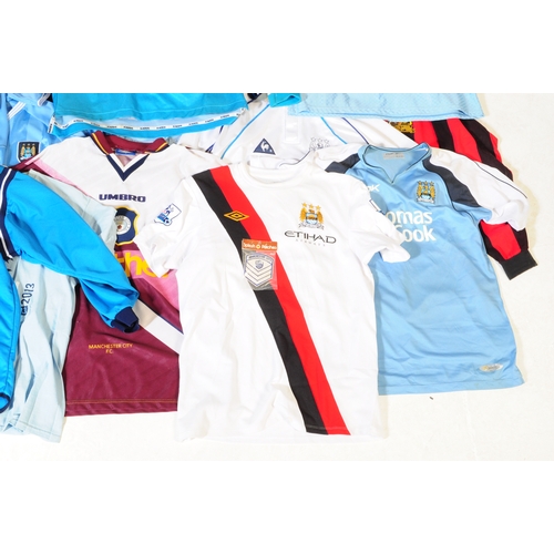 399 - A large collection of vintage 20th century and later Manchester City Football club shirts, T shirts ... 