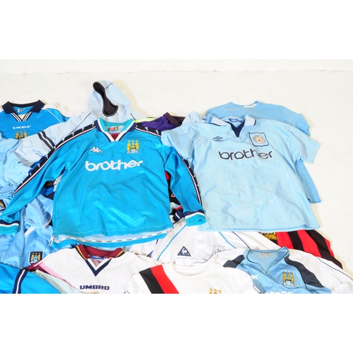 399 - A large collection of vintage 20th century and later Manchester City Football club shirts, T shirts ... 
