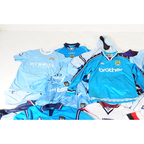399 - A large collection of vintage 20th century and later Manchester City Football club shirts, T shirts ... 