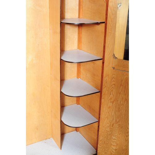 561 - A 1930s Art Deco oak bachelors wardrobe. Raised on an plinth leg base with twin full length oak vene... 