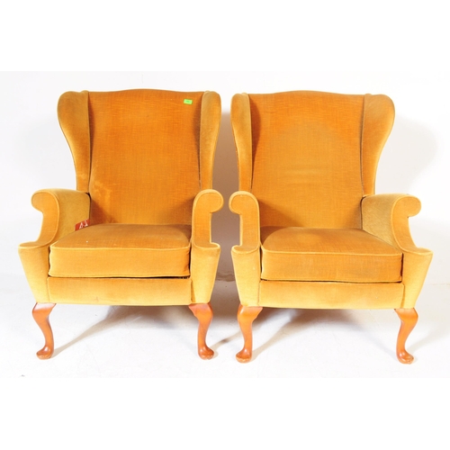 566 - Parker Knoll - A pair of vintage retro mid 20th century Parker Knoll wing back armchairs upholstered... 