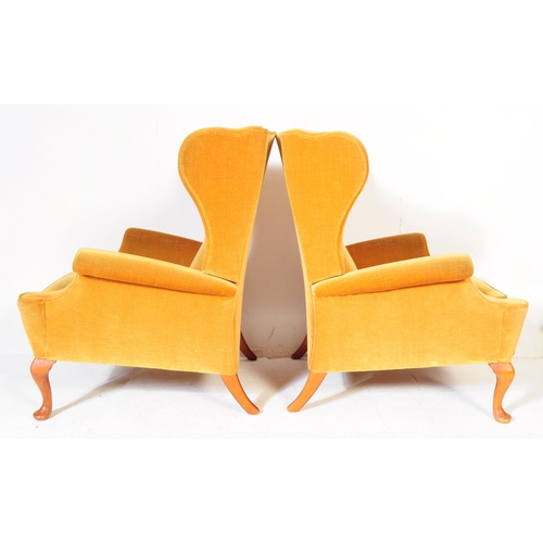566 - Parker Knoll - A pair of vintage retro mid 20th century Parker Knoll wing back armchairs upholstered... 