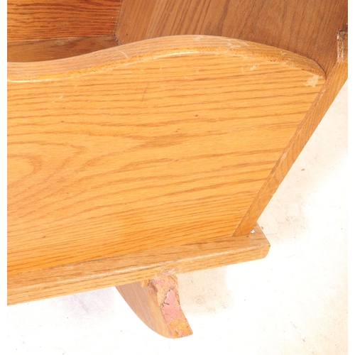 575 - A vintage late 19th century Victorian child's oak rocking cradle. The cradle with solid panels on ca... 