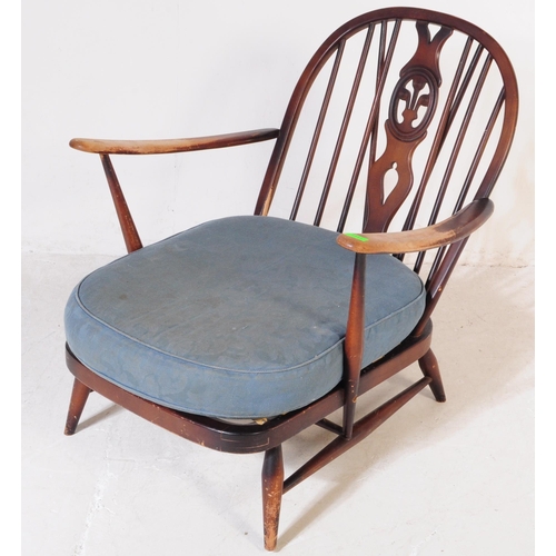644A - Ercol Furniture - A mid 20th century beech and elm Ercol Fleur De Lys pattern Windsor armchair. the ... 