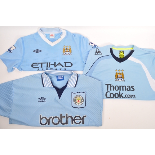 399 - A large collection of vintage 20th century and later Manchester City Football club shirts, T shirts ... 