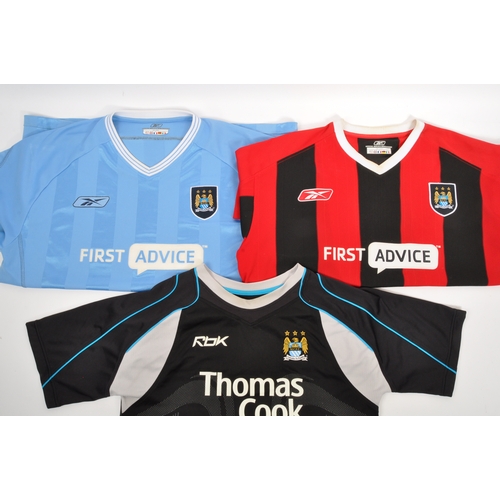 399 - A large collection of vintage 20th century and later Manchester City Football club shirts, T shirts ... 