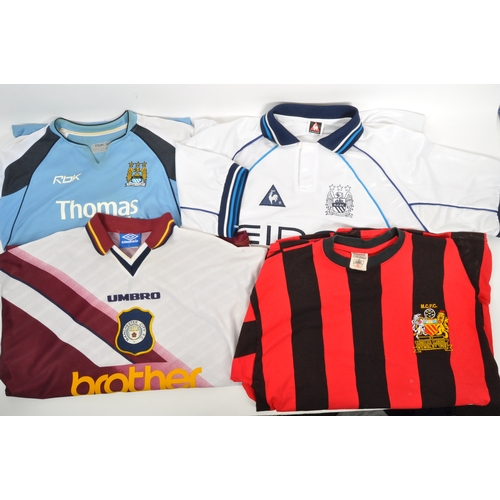 399 - A large collection of vintage 20th century and later Manchester City Football club shirts, T shirts ... 