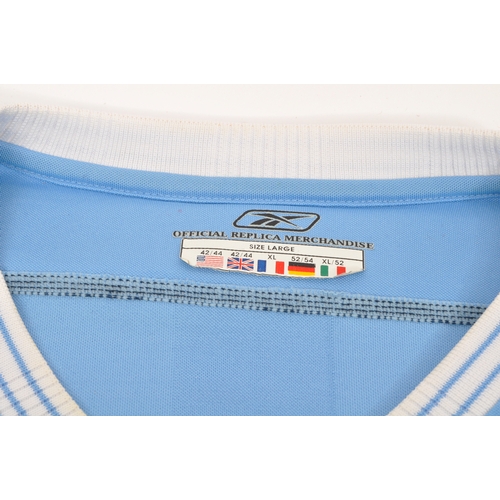 399 - A large collection of vintage 20th century and later Manchester City Football club shirts, T shirts ... 