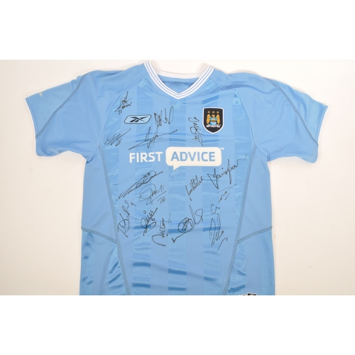 399 - A large collection of vintage 20th century and later Manchester City Football club shirts, T shirts ... 