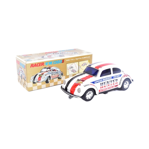 34 - Tinplate Toys - a vintage Japanese (Taiyo) tinplate battery operated Volkswagen Racer 1303S with Bum... 