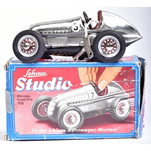 58 - Schuco - x2 Schuco made tinplate clockwork models comprising; 1050 Mercedes Grand Prix 1936 (with ke... 