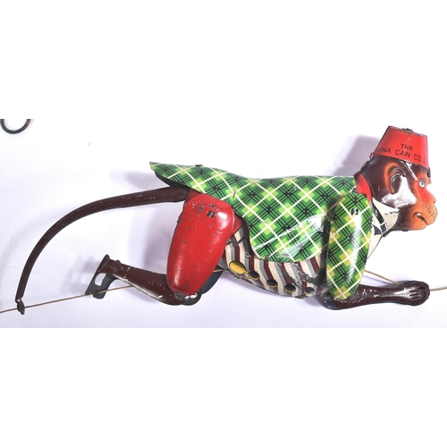 64 - Tinplate Toys - a vintage tinplate mechanical climbing monkey. The monkey suspended on a string that... 